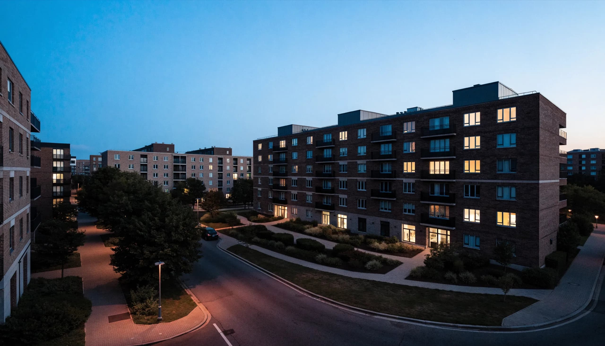 Apartment community lit at dusk.